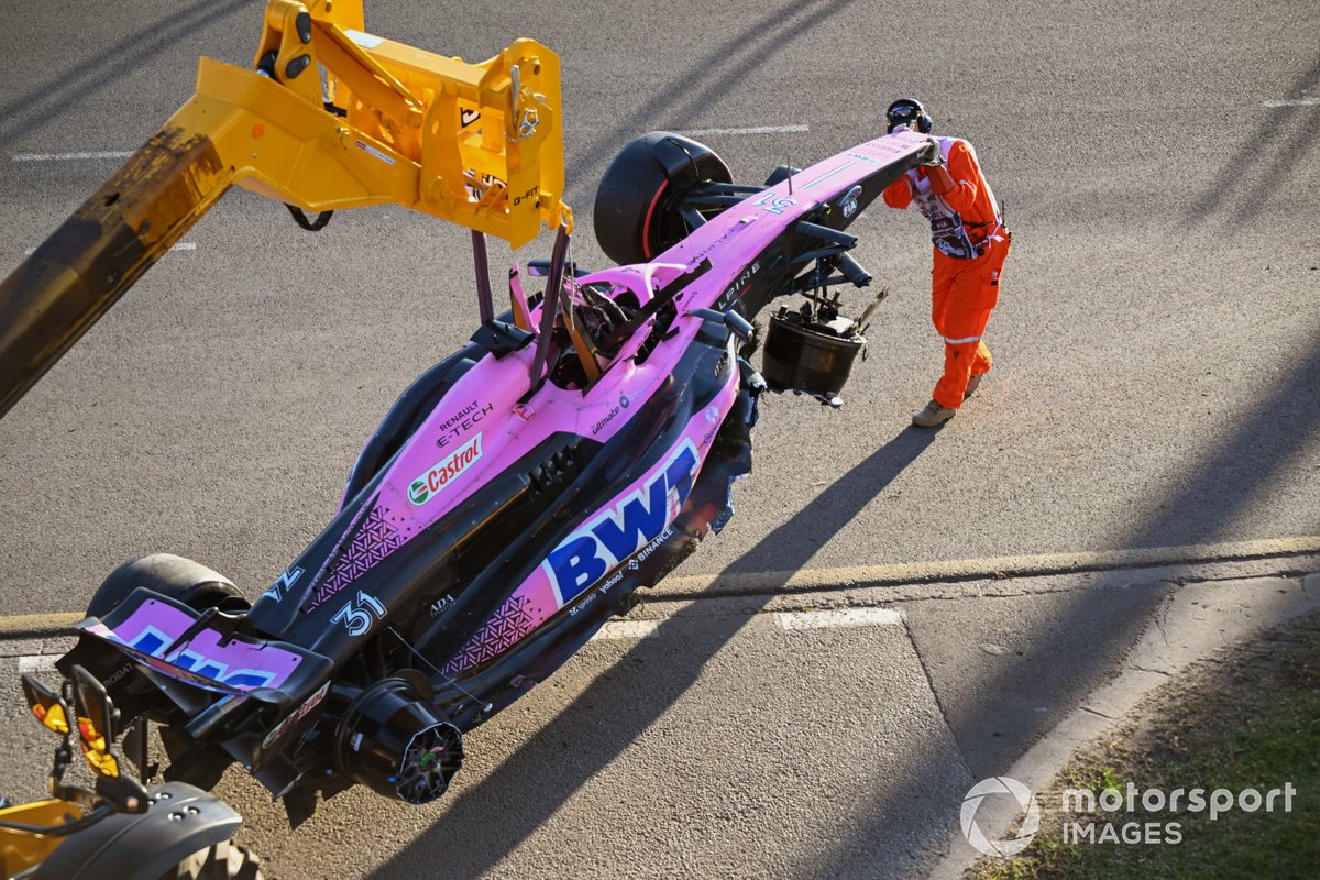 Marshals remove the damaged car of Esteban Ocon, Alpine A523, from the circuit after the race