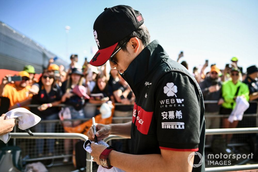 Zhou Guanyu, Alfa Romeo F1 Team, signs autographs for fans