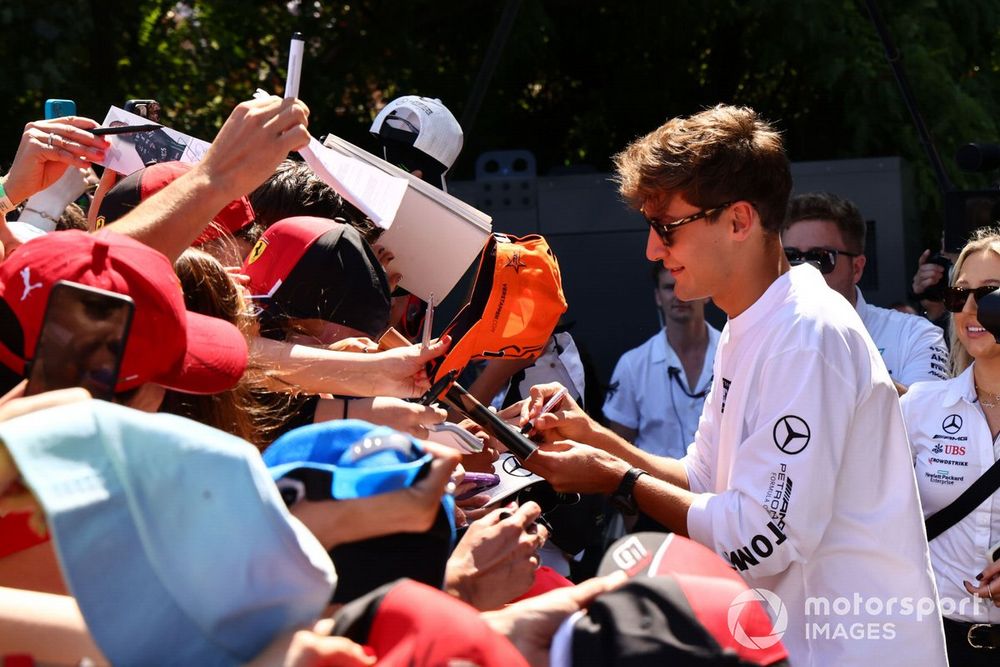 George Russell, Mercedes-AMG signs an autograph for a fan