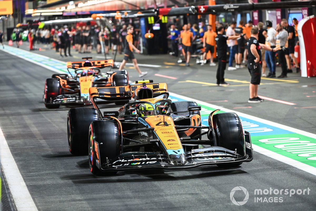 Lando Norris, McLaren MCL60, Oscar Piastri, McLaren MCL60, in the pit lane