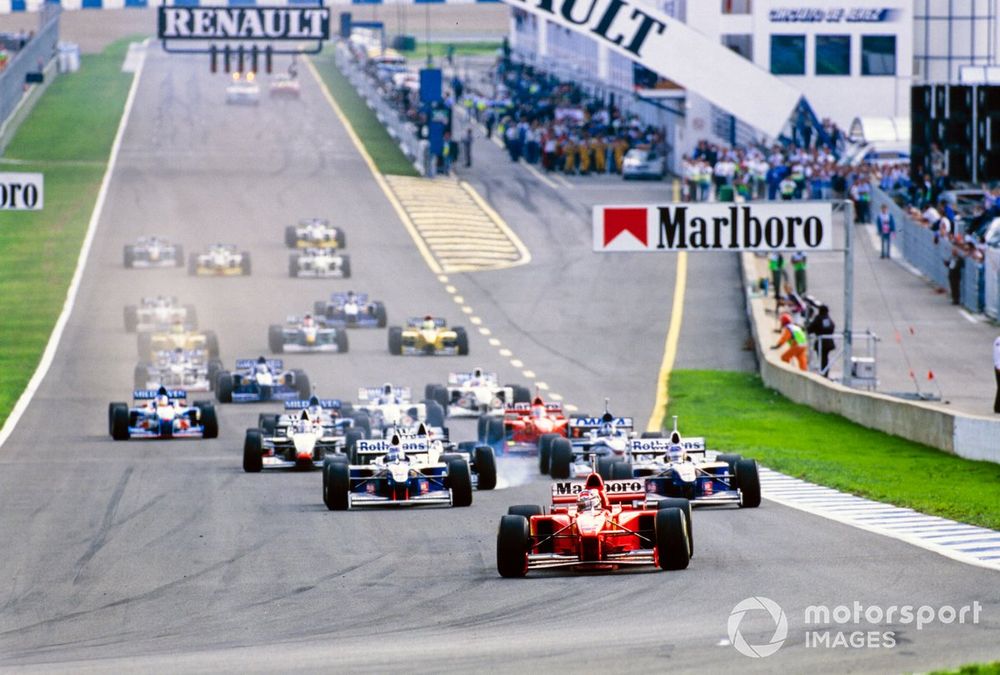 Michael Schumacher, Ferrari F310B, leads the field at the start