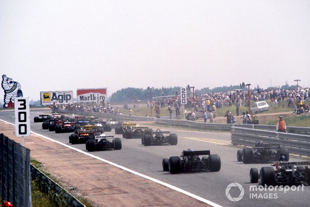 The field heads towards the first corner at the start of the race
