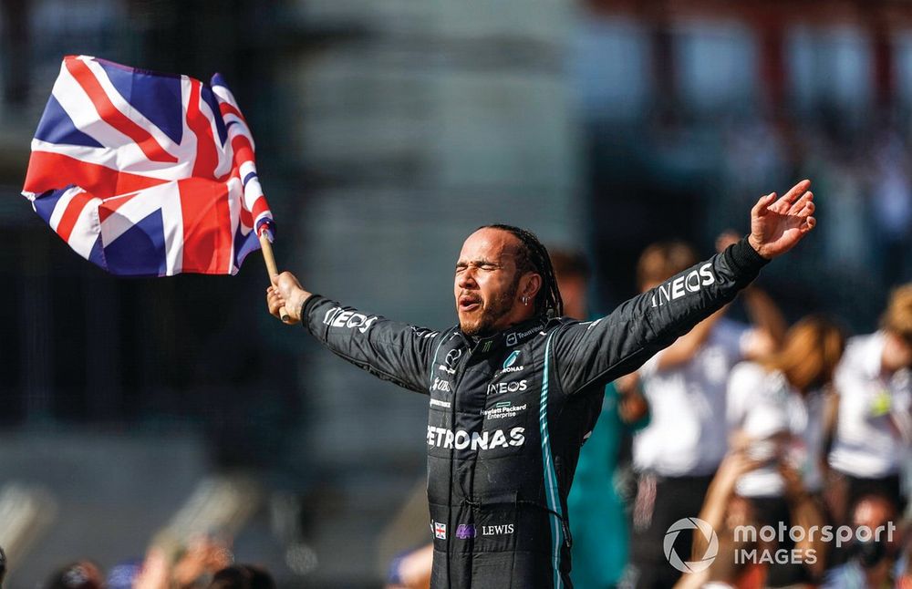 Lewis Hamilton, Mercedes, 1st position, celebrates after the race with a Union flag
