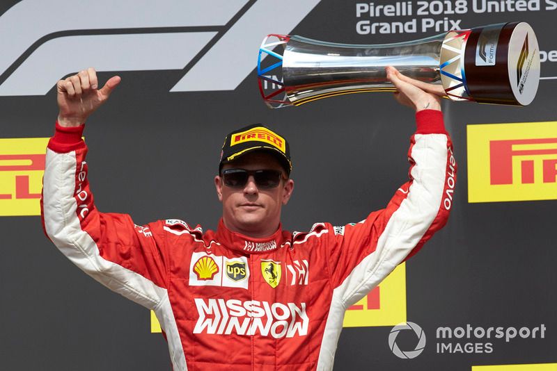 Kimi Raikkonen, Ferrari, 1st position, lifts his trophy on the podium