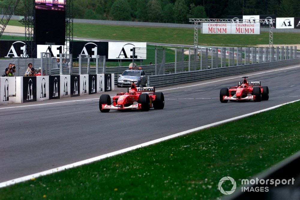 Michael Schumacher, Ferrari F2002, follows team orders and takes over team mate Rubens Barrichello, Ferrari F2002