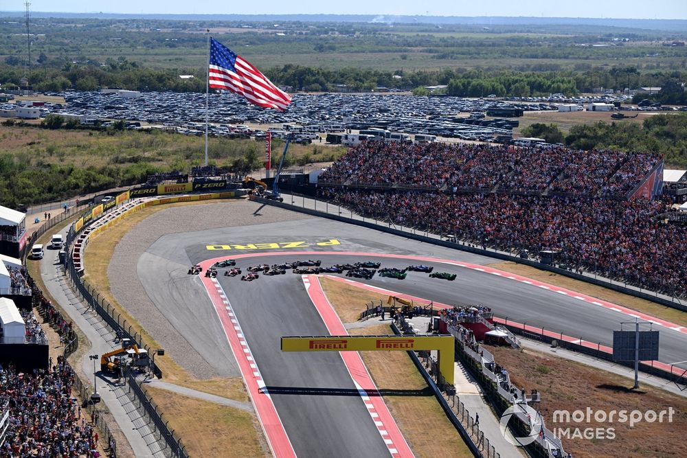 Max Verstappen, Red Bull Racing RB20, Lando Norris, McLaren MCL38 battle into the first corner, followed by Charles Leclerc, Ferrari SF-24, Carlos Sainz, Ferrari SF-24 