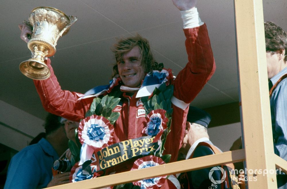 James Hunt celebrates victory on the podium. He would later be disqualified from the results.