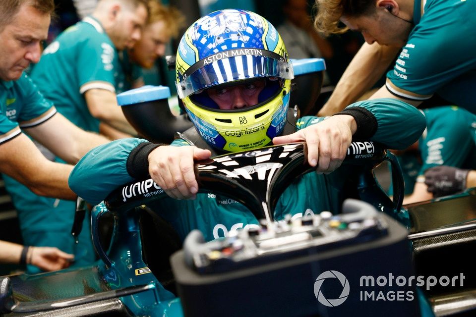 Fernando Alonso, Aston Martin F1 Team, settles into the car