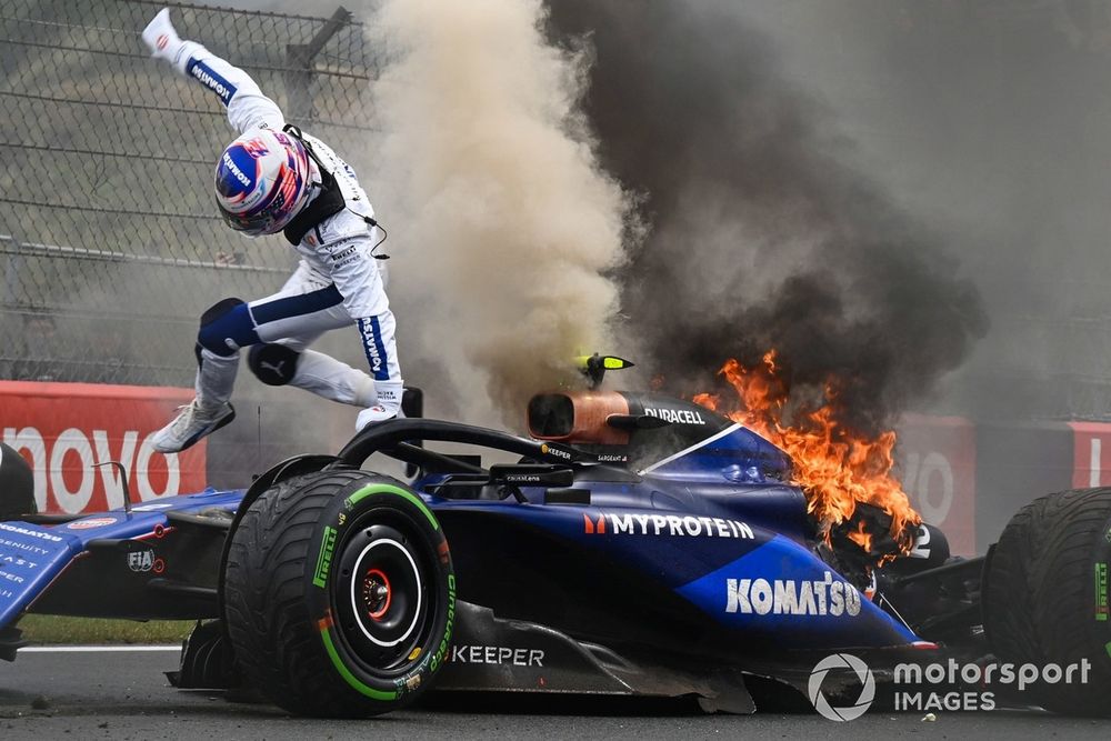 Logan Sargeant, Williams FW46, jumps out of his car after a crash